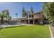 Large backyard with artificial turf, pool, and covered patio at 1927 E Ranch Rd, Tempe, AZ 85284