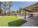 Spacious backyard with artificial turf, covered patio, and fenced pool at 1927 E Ranch Rd, Tempe, AZ 85284