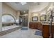 Luxurious bathroom featuring double sinks, vanity, bathtub, shower, and tile floors at 1927 E Ranch Rd, Tempe, AZ 85284