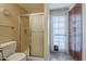 Bathroom featuring a glass door shower, toilet, and a cupboard at 1927 E Ranch Rd, Tempe, AZ 85284
