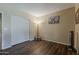 Bright bedroom features hardwood floors, a closet, and neutral colored walls at 1927 E Ranch Rd, Tempe, AZ 85284