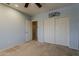 Light blue bedroom featuring a ceiling fan, closet, and access to another room at 1927 E Ranch Rd, Tempe, AZ 85284