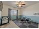 Bedroom featuring a ceiling fan, and excercise equipment set upon a black mat at 1927 E Ranch Rd, Tempe, AZ 85284