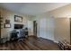 Bedroom featuring a workspace, dark wood floors, and access to an adjacent room at 1927 E Ranch Rd, Tempe, AZ 85284