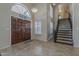 Foyer featuring a staircase, tiled flooring, and a large wooden front door at 1927 E Ranch Rd, Tempe, AZ 85284