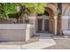 Beautiful entrance to house features a unique arched entryway and lush landscaping at 1927 E Ranch Rd, Tempe, AZ 85284