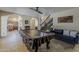 Large game room features a pool table, easy access to the kitchen, and a staircase at 1927 E Ranch Rd, Tempe, AZ 85284