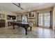 Spacious game room featuring a pool table, brick fireplace, and access to the backyard at 1927 E Ranch Rd, Tempe, AZ 85284