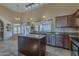 Open kitchen with island, stainless steel appliances, granite countertops, and lots of natural light at 1927 E Ranch Rd, Tempe, AZ 85284