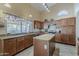 Bright kitchen with stainless steel appliances, granite counters, and breakfast bar island at 1927 E Ranch Rd, Tempe, AZ 85284