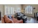Comfortable living room featuring hardwood floors, neutral walls, and bright, shuttered windows at 1927 E Ranch Rd, Tempe, AZ 85284