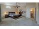 Spacious main bedroom featuring a ceiling fan, ensuite bathroom and walk-in closet at 1927 E Ranch Rd, Tempe, AZ 85284