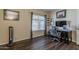 Home office with wood floors, natural light, desk, rolling chair, and decor at 1927 E Ranch Rd, Tempe, AZ 85284