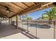 Covered patio overlooking private pool and backyard oasis with palm trees at 1927 E Ranch Rd, Tempe, AZ 85284