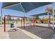 Community playground featuring swings and slides under shaded canopies, perfect for Gathering fun at 1927 E Ranch Rd, Tempe, AZ 85284