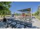 Community playground featuring covered picnic areas, play structures, and a grassy field at 1927 E Ranch Rd, Tempe, AZ 85284