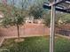 Backyard view with artificial turf, trees, and a brick wall providing privacy at 19814 N 49Th Dr, Glendale, AZ 85308
