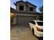 Front exterior view of a two-story home with a two-car garage and a car in the driveway at 19814 N 49Th Dr, Glendale, AZ 85308