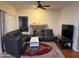 Cozy living room featuring a fireplace, leather sectional sofa, and area rug at 19814 N 49Th Dr, Glendale, AZ 85308
