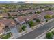 Neighborhood aerial view highlighting houses with tile roofs and a neighborhood street at 19905 E Apricot Ln, Queen Creek, AZ 85142