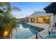 Inviting backyard pool, with lounge seating, palm trees and a view of the patio at 19905 E Apricot Ln, Queen Creek, AZ 85142