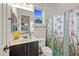 Charming bathroom features a single sink vanity, decorative butterfly shower curtain, and ample natural light at 19905 E Apricot Ln, Queen Creek, AZ 85142