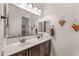 Bright bathroom featuring double sinks, plenty of counter space, and large mirrors at 19905 E Apricot Ln, Queen Creek, AZ 85142