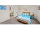 Cozy bedroom with a light blue bedspread, artwork, and view to the attached bathroom at 19905 E Apricot Ln, Queen Creek, AZ 85142