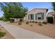 Inviting single-story home showcasing a desert front yard and a sidewalk leading to the entrance at 19905 E Apricot Ln, Queen Creek, AZ 85142
