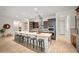 Open kitchen featuring a spacious island with seating, stainless steel appliances, and ample counter space at 19905 E Apricot Ln, Queen Creek, AZ 85142