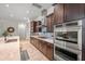 Bright kitchen with stainless steel double oven, a gas cooktop, granite countertops, and ample wood cabinetry at 19905 E Apricot Ln, Queen Creek, AZ 85142