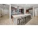Modern kitchen with stainless steel appliances, a large island with bar seating, and wood cabinets at 19905 E Apricot Ln, Queen Creek, AZ 85142