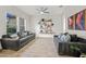 Bright living room with stylish decor, tile floors, a ceiling fan, and large windows at 19905 E Apricot Ln, Queen Creek, AZ 85142