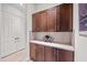 This walk-in pantry features beautiful wooden cabinets and shelving with a light countertop at 19905 E Apricot Ln, Queen Creek, AZ 85142