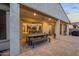 Covered patio with ample seating, dining area, ceiling fans, and backyard access at 19905 E Apricot Ln, Queen Creek, AZ 85142