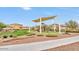 Community playground with a shade covering and slide on a sunny day at 19905 E Apricot Ln, Queen Creek, AZ 85142