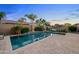 Backyard oasis featuring a sparkling pool, lush landscaping, and lounge area at 19905 E Apricot Ln, Queen Creek, AZ 85142