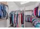 Spacious walk-in closet offering ample storage with custom shelving and hanging racks for organization at 19905 E Apricot Ln, Queen Creek, AZ 85142
