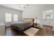 Bright bedroom featuring a comfortable bed, hard wood floors, and a view into the attached bathroom at 20121 N 76Th St # 2006, Scottsdale, AZ 85255