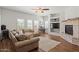 Inviting living room features a stone fireplace, hardwood floors, and ample natural light at 20121 N 76Th St # 2006, Scottsdale, AZ 85255