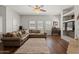 Cozy living room boasts hardwood floors, large windows, and a comfortable leather sofa at 20121 N 76Th St # 2006, Scottsdale, AZ 85255