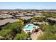 Aerial view of a community pool with lounge chairs and desert landscaping at 20121 N 76Th St # 2006, Scottsdale, AZ 85255