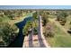 Scenic aerial view of community featuring a golf course, lake, lush landscaping and gated entry at 2041 W Hemlock Way, Chandler, AZ 85248