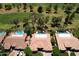 Aerial view of a beautiful home with a backyard pool, mature trees and a golf course view at 2041 W Hemlock Way, Chandler, AZ 85248