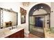 This bathroom features a glass enclosed shower, custom vanity and ceramic tile flooring at 2041 W Hemlock Way, Chandler, AZ 85248