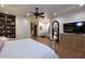 Comfortable bedroom with tiled floors, ceiling fan, and ample natural light at 2041 W Hemlock Way, Chandler, AZ 85248