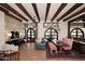 Open-concept dining room with wooden beams, terracotta tile, an area rug, and rustic furniture at 2041 W Hemlock Way, Chandler, AZ 85248