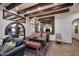 Elegant dining room with exposed wood beams, terracotta floors, and ornate chandelier at 2041 W Hemlock Way, Chandler, AZ 85248
