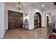 Entrance foyer featuring tiled floors, decorative lighting, and arched doorways to living spaces at 2041 W Hemlock Way, Chandler, AZ 85248