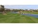 Picturesque golf course view featuring a water hazard, lush green fairways, and palm trees at 2041 W Hemlock Way, Chandler, AZ 85248